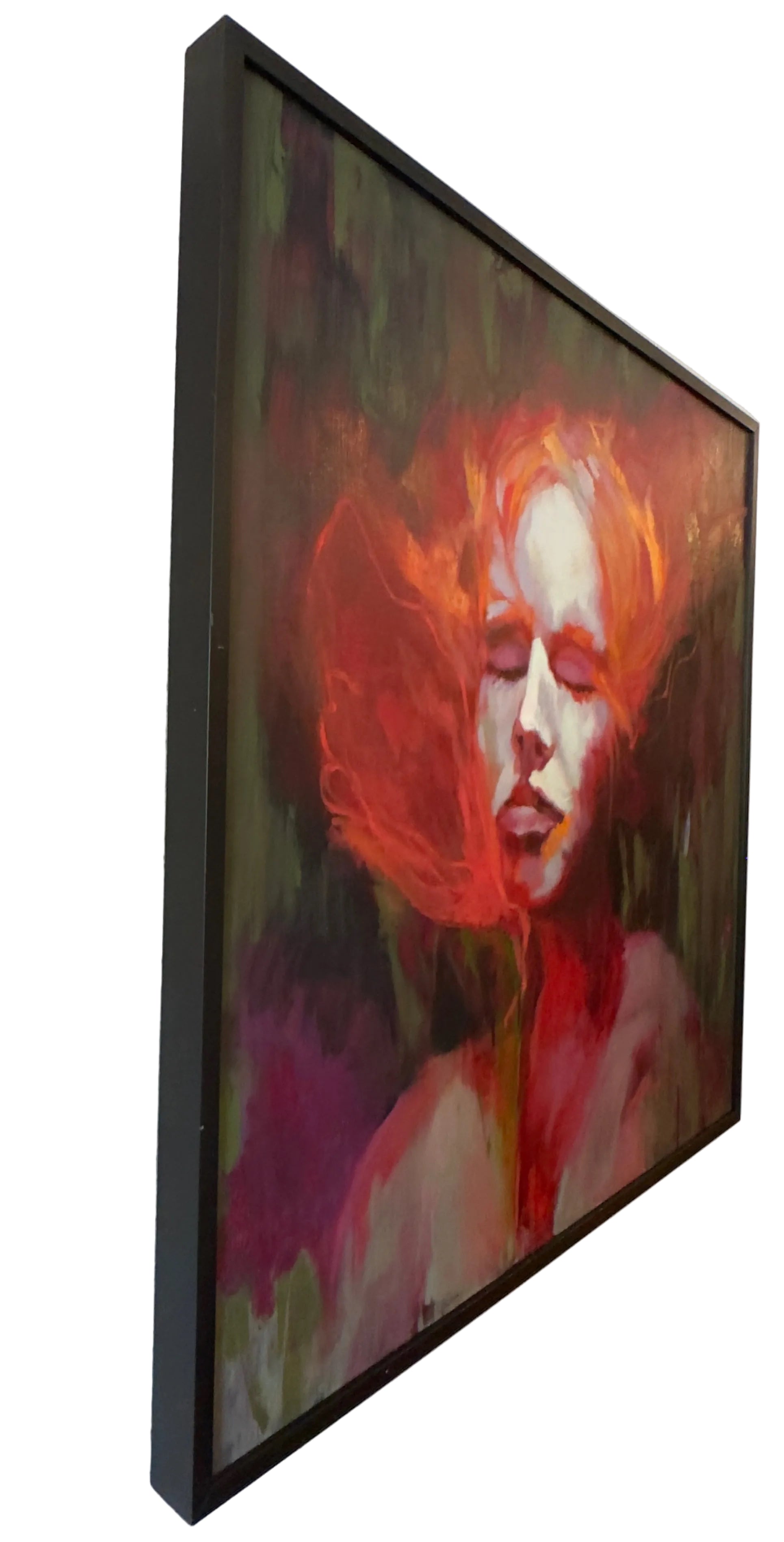 A framed canvas painting of a woman with vibrant red hair and closed eyes.