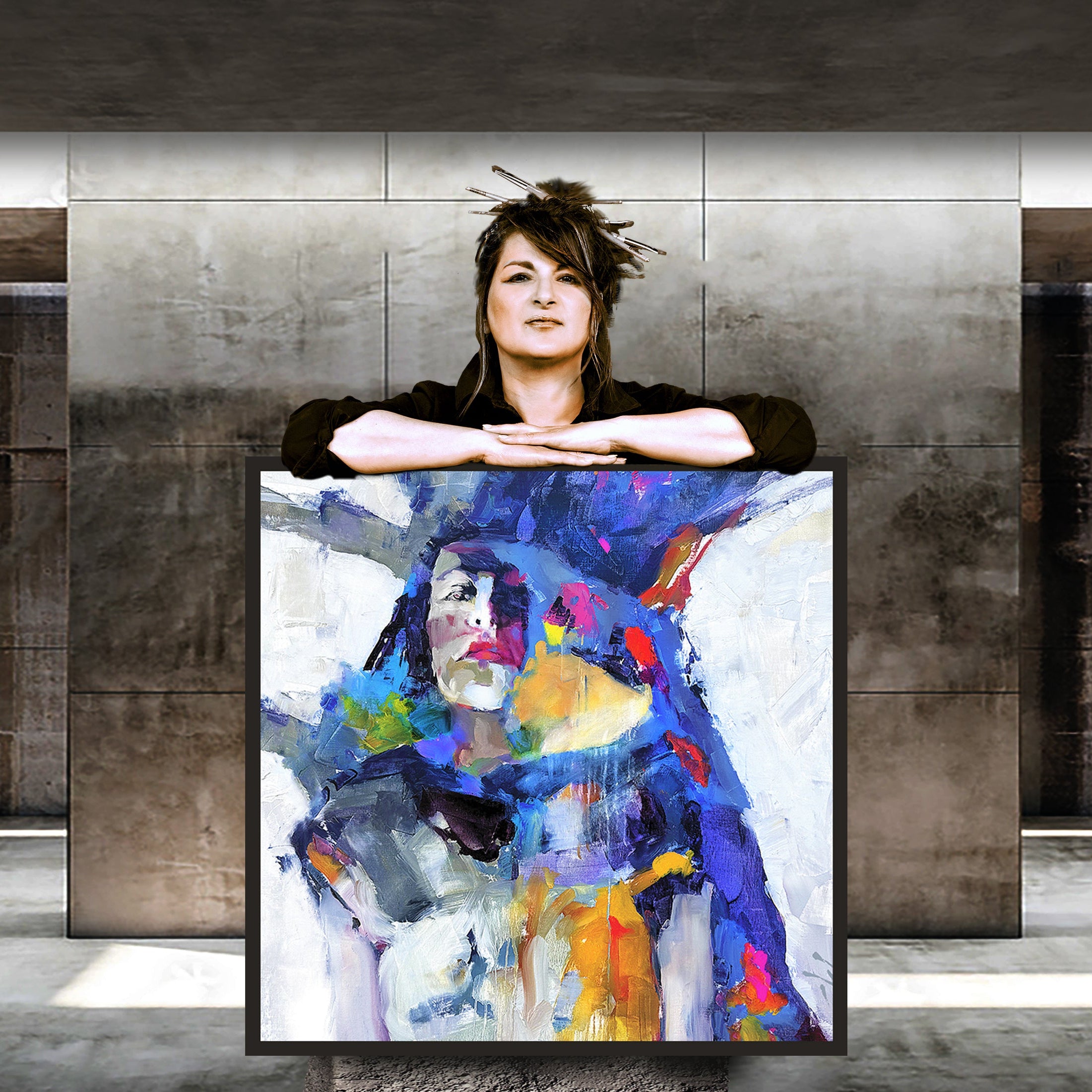 ARTIST Michelle Carnes holding a colorful  painting in an indoor setting